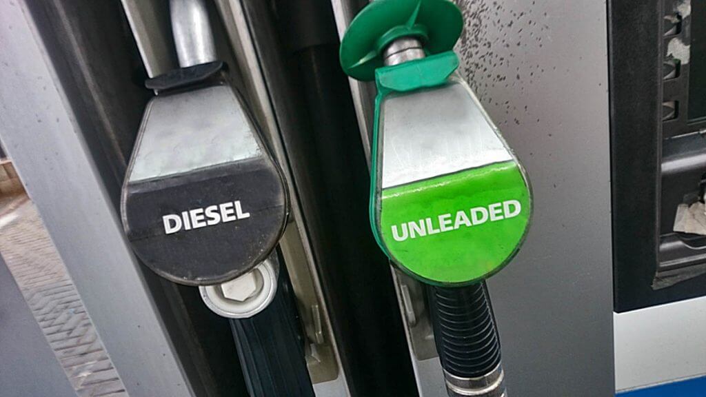 Diesel and unleaded fuel pump nozzles at a petrol station