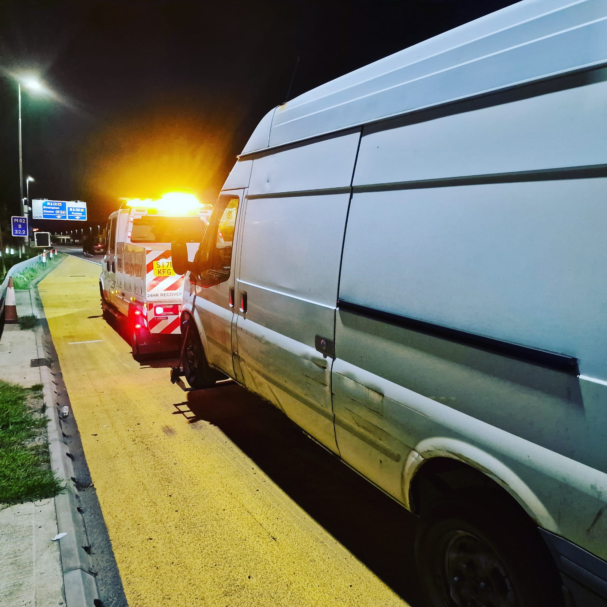 Simon smiling while towing a Kia Picanto.