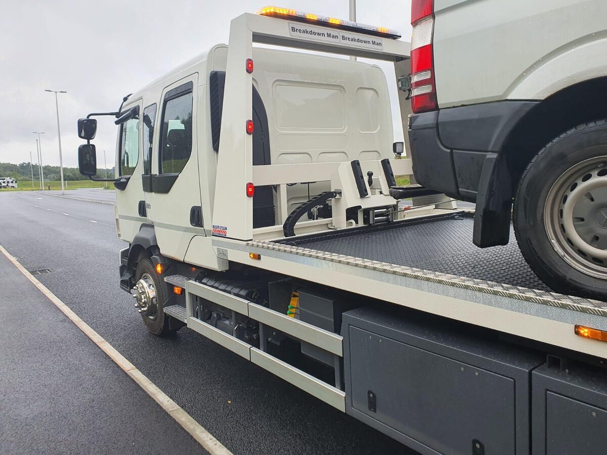 Breakdown Man Iveco flatbed truck on the roadside with a casualty van behind it on the way back from Blackpool.