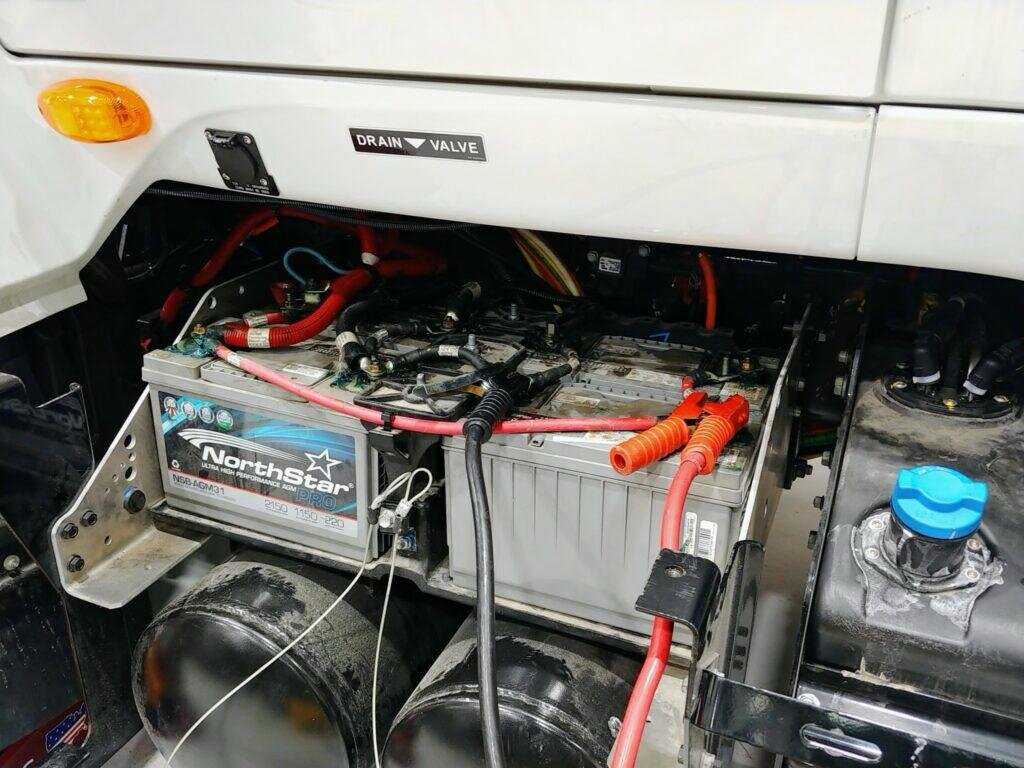 HGV battery compartment showing twin NorthStar AGM commercial batteries during a 24-volt jump-start callout.