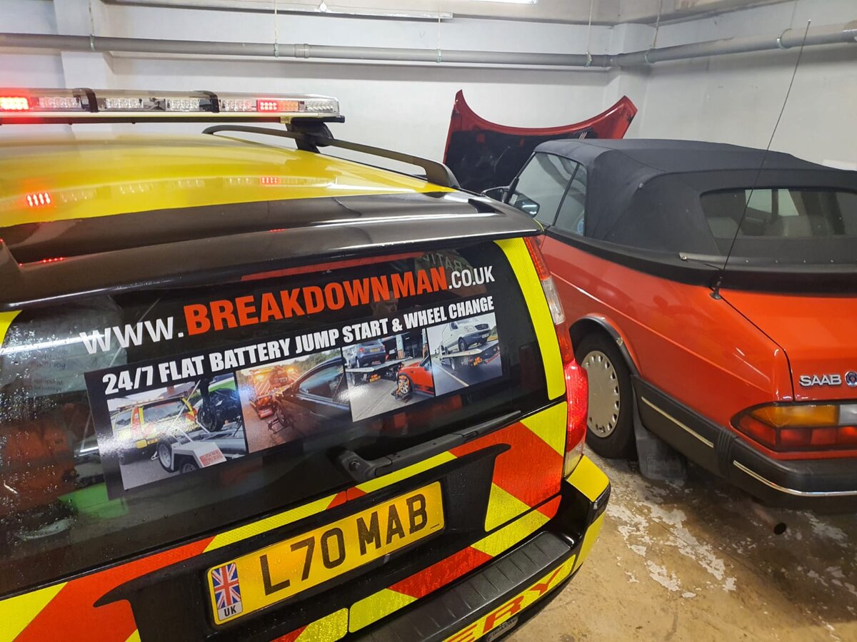 Highway-maintenance car wrapped in Breakdown Man yellow battenburg livery advertising 24/7 flat battery, jump-start and wheel-change services, parked in the garage en route to Sheffield.