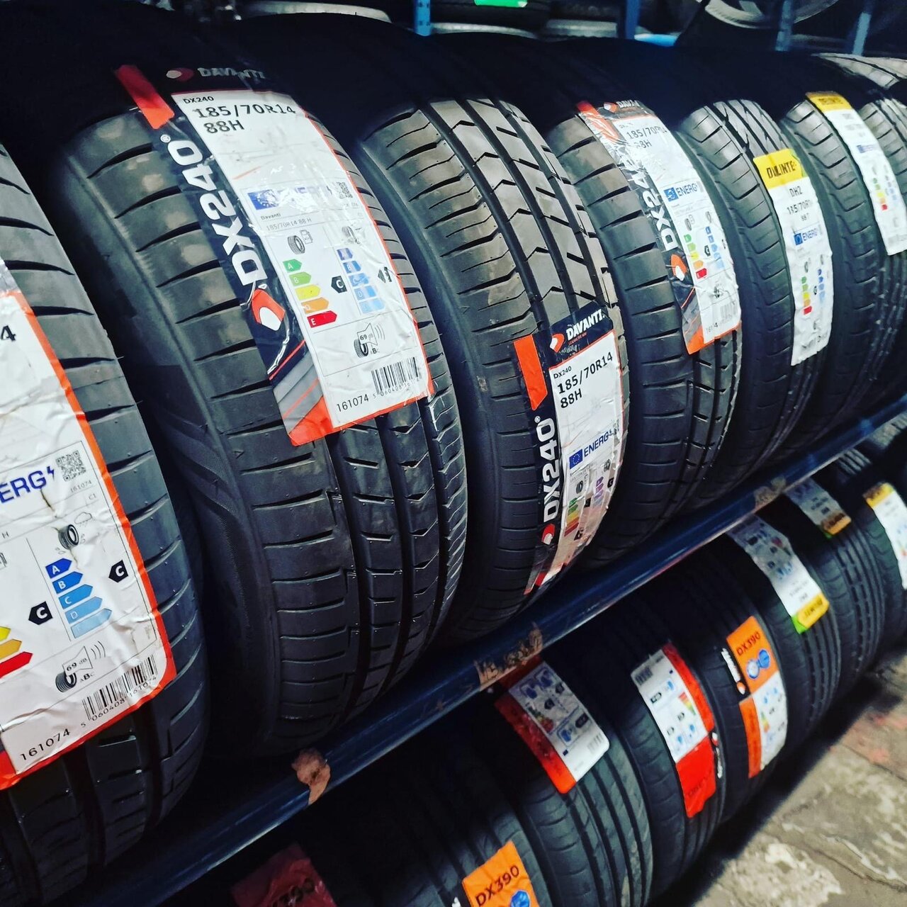 Rack of new branded tyres stocked at the fitting bay