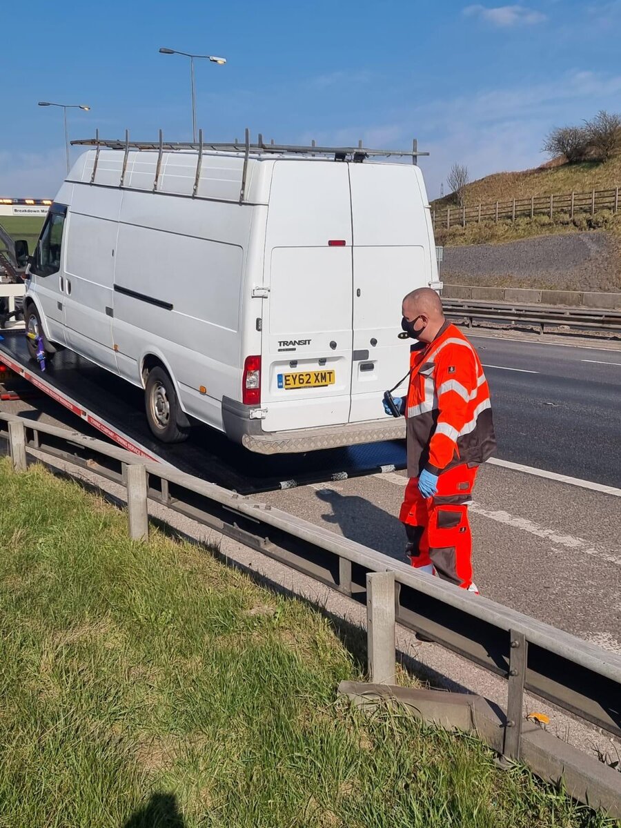 White Ford Transit van loaded onto the Breakdown Man flatbed for a roadside recovery near Wigan.