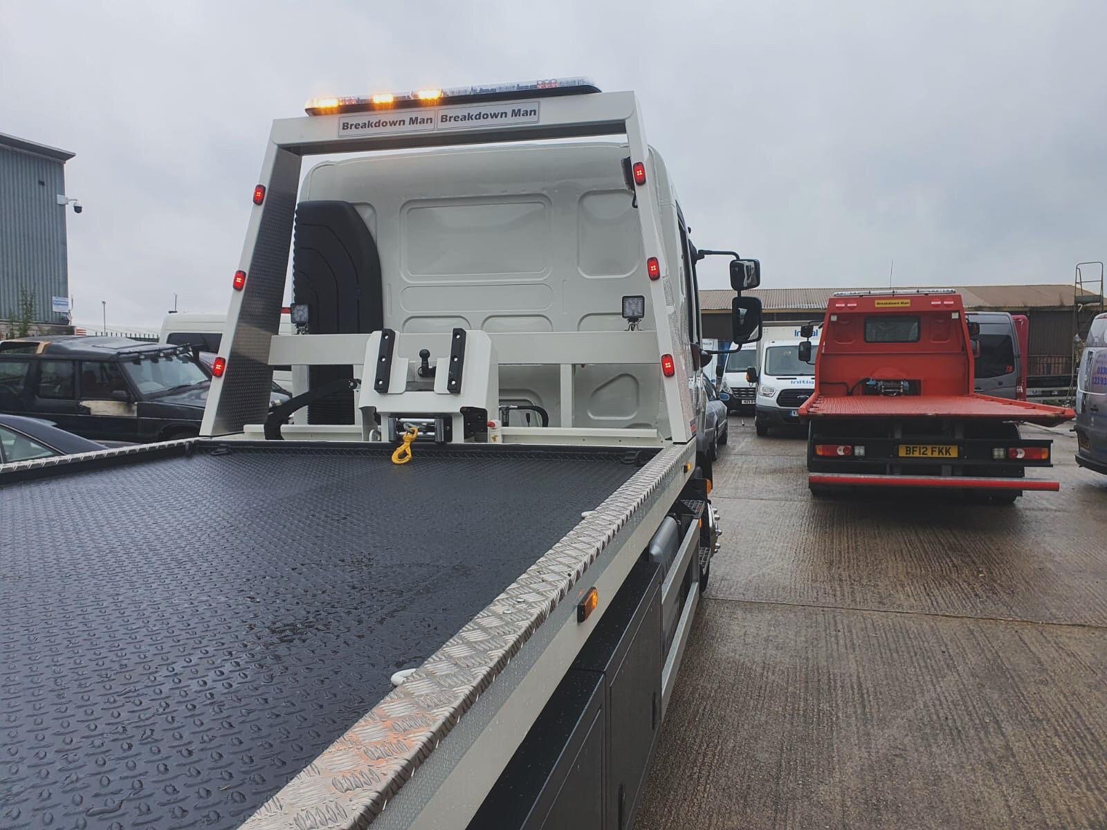 The Breakdown Man flatbed recovery truck at the depot, branded with light bar and beacon, ready to dispatch.