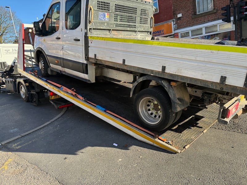 Recovery truck loading a white van for breakdown towing near Tyldesley.